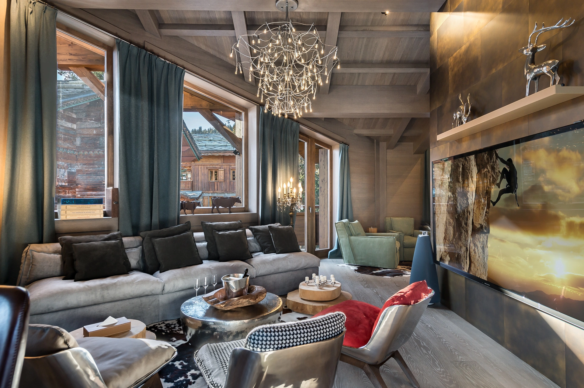 Grand chalet living room with chandeliers and mountain views